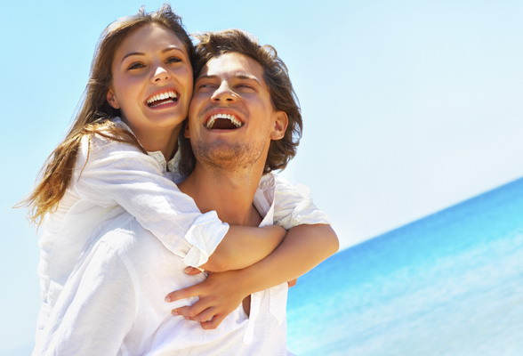 An attractive couple playing around on the beach