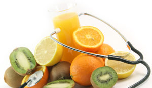 phonedoscope on glass of juice with fruits oranges lemons and kiwi isolated on white background agriculture and healthy eating