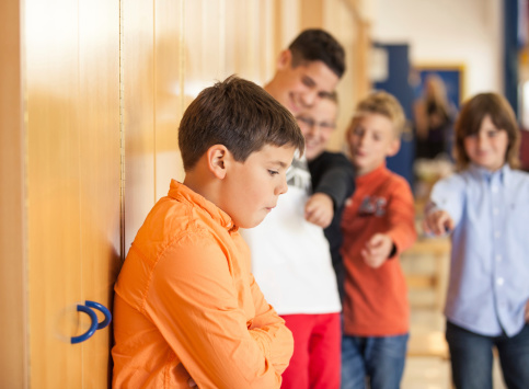 Teenagers bullying friend at the school