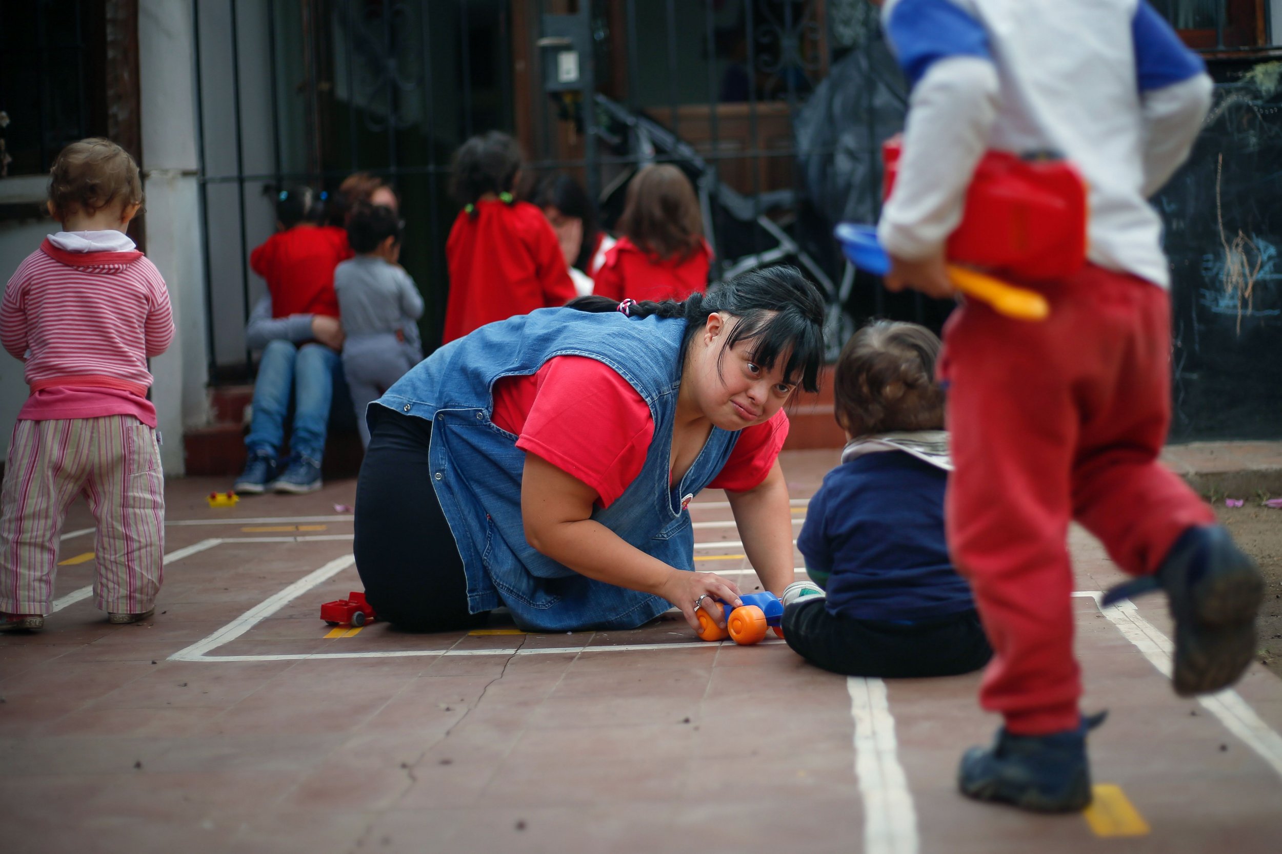 Noelia Garella (C), a kindergarten teacher born with Down Syndrome, plays with children at the Jeromito kindergarten in Cordoba, Argentina on September 29, 2016. When Noelia Garella was a child, a nursery school rejected her as a "monster." Now 31, she is in a class of her own. In the face of prejudice, she is the first person with Down syndrome to work as a kindergarten teacher in Argentina -- and one of few in the world.  / AFP PHOTO / DIEGO LIMADIEGO LIMA/AFP/Getty Images