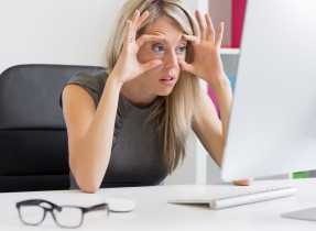 Tired woman in front of computer