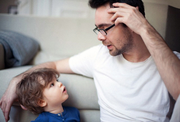 Father talking to young son, portrait