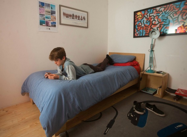 SENT UNDER EMBARGO - NO USE BEFORE 00.01 DECEMBER 13 2016. Dylan Kissling aged 13, shows how he used to use his phone at his home in Goldsithney, Cornwall. See SWNS story SWMOBILE. A woman who banned her 13 year-old son from his mobile phone says they have never been happier - and is urging other parents to do the same. Yoga teacher Karly Tophill, 41, confiscated Dylan's iPhone 4 back in October because he was spending too much time on it. He sulked at first but Karly then started to notice a dramatic change, saying her oldest child became more engaged, talkative and better with his homework.