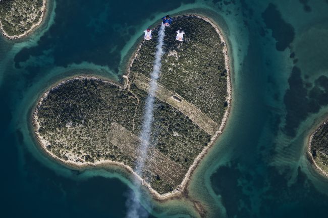 Marco Waltenspiel, Amy Chmelecki and Marco Fuerst fly their wingsuits over the heart island near Zadar, Croatia, November 30, 2016 // Wolfgang Lienbacher / Red Bull Content Pool // For more content, pictures and videos like this please go to www.redbullcontentpool.com