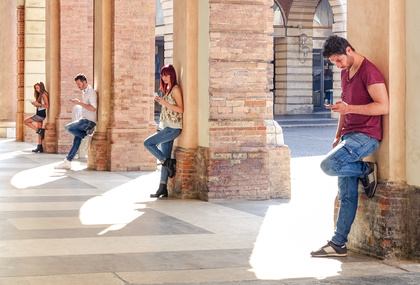 Group of young fashion friends using smartphone in urban old city center - Technology addiction in actual lifestyle with mutual disinterest towards each other - Addicted people to modern mobile phones