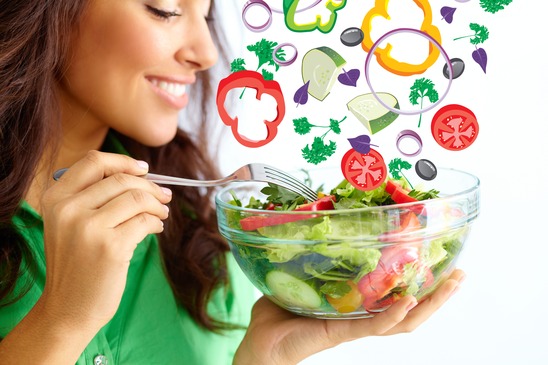 Close-up of pretty girl eating fresh vegetable salad