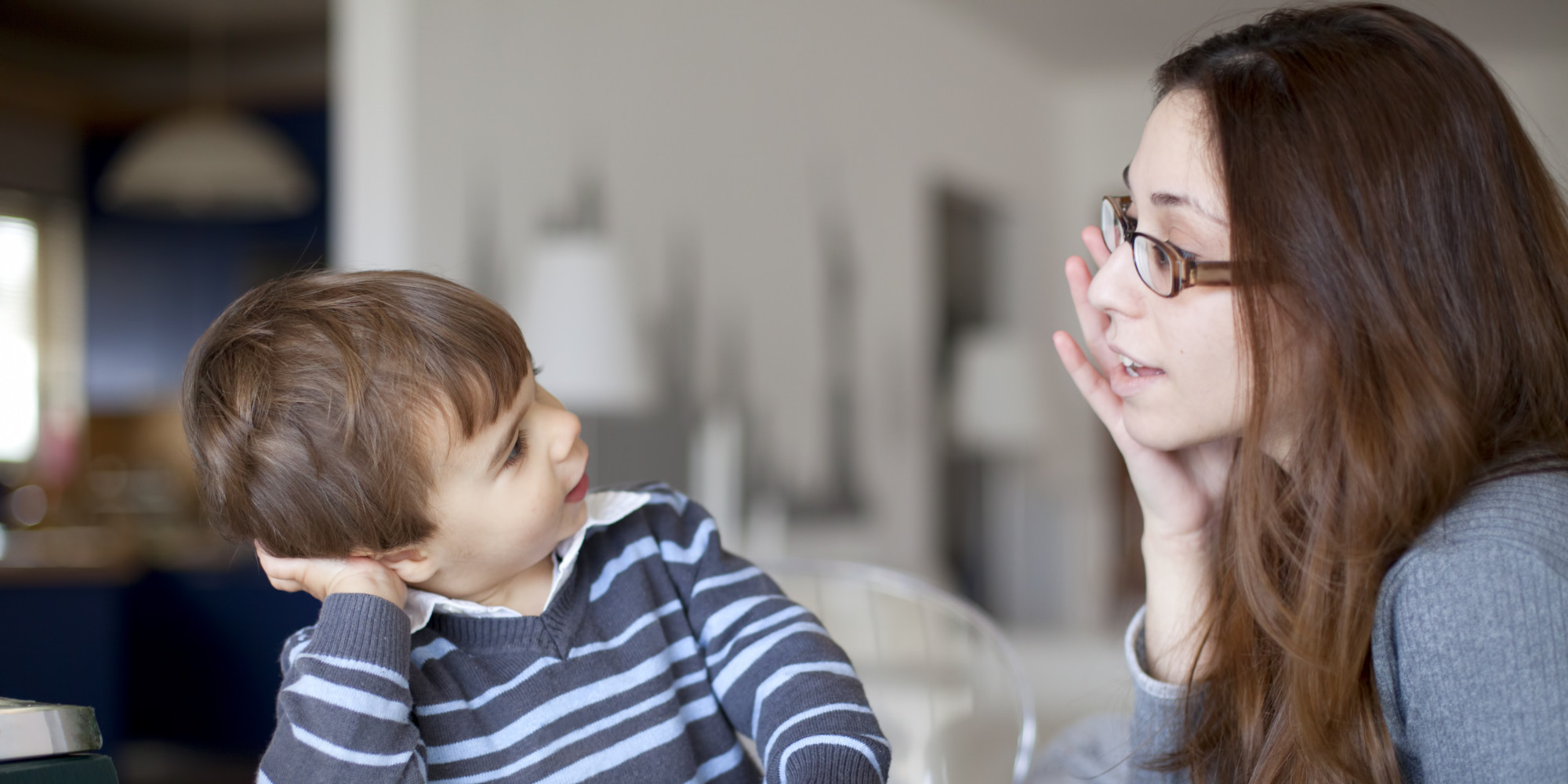 Small boy talking to his mother