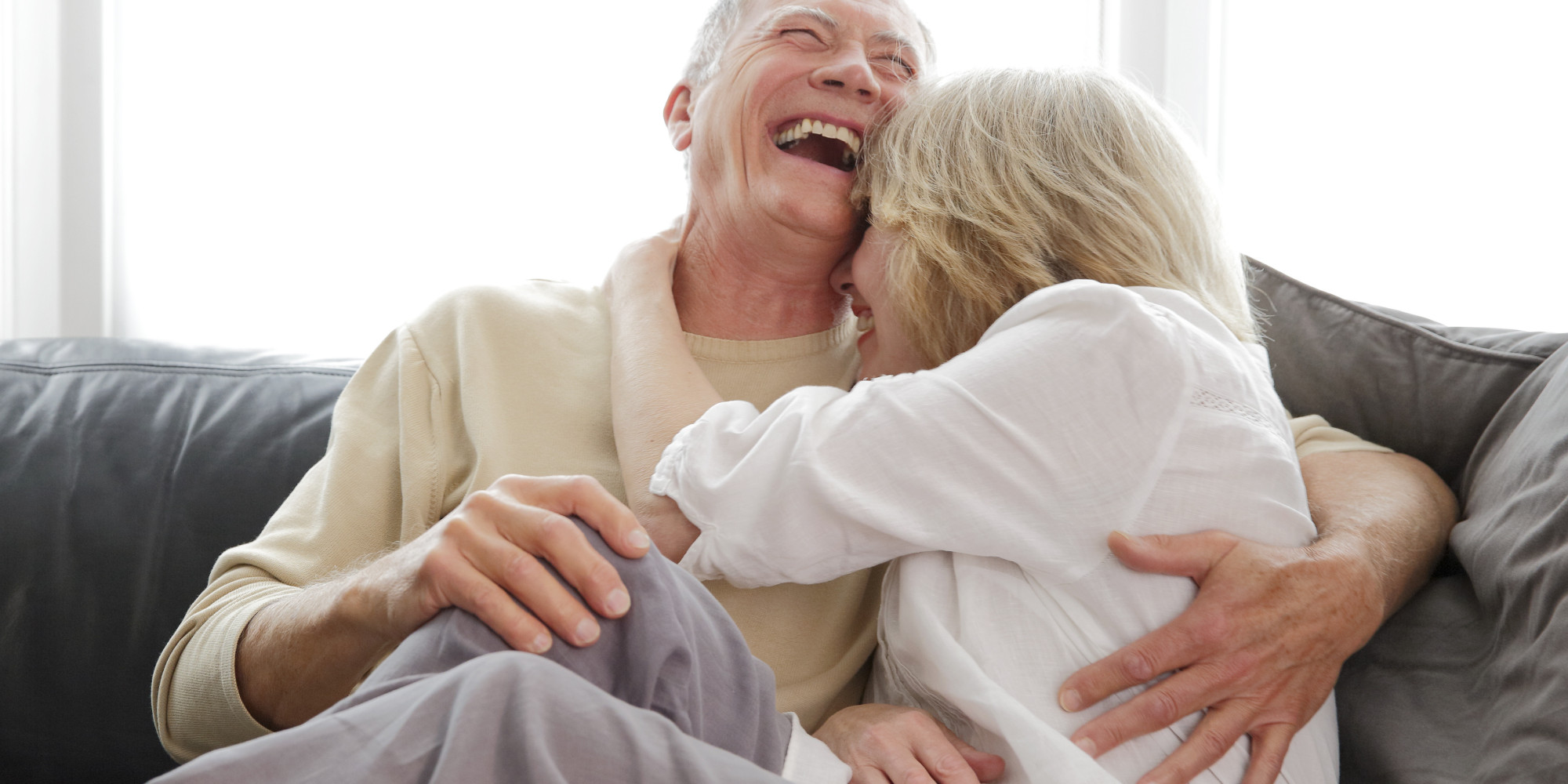 Mature couple laughing and cuddling