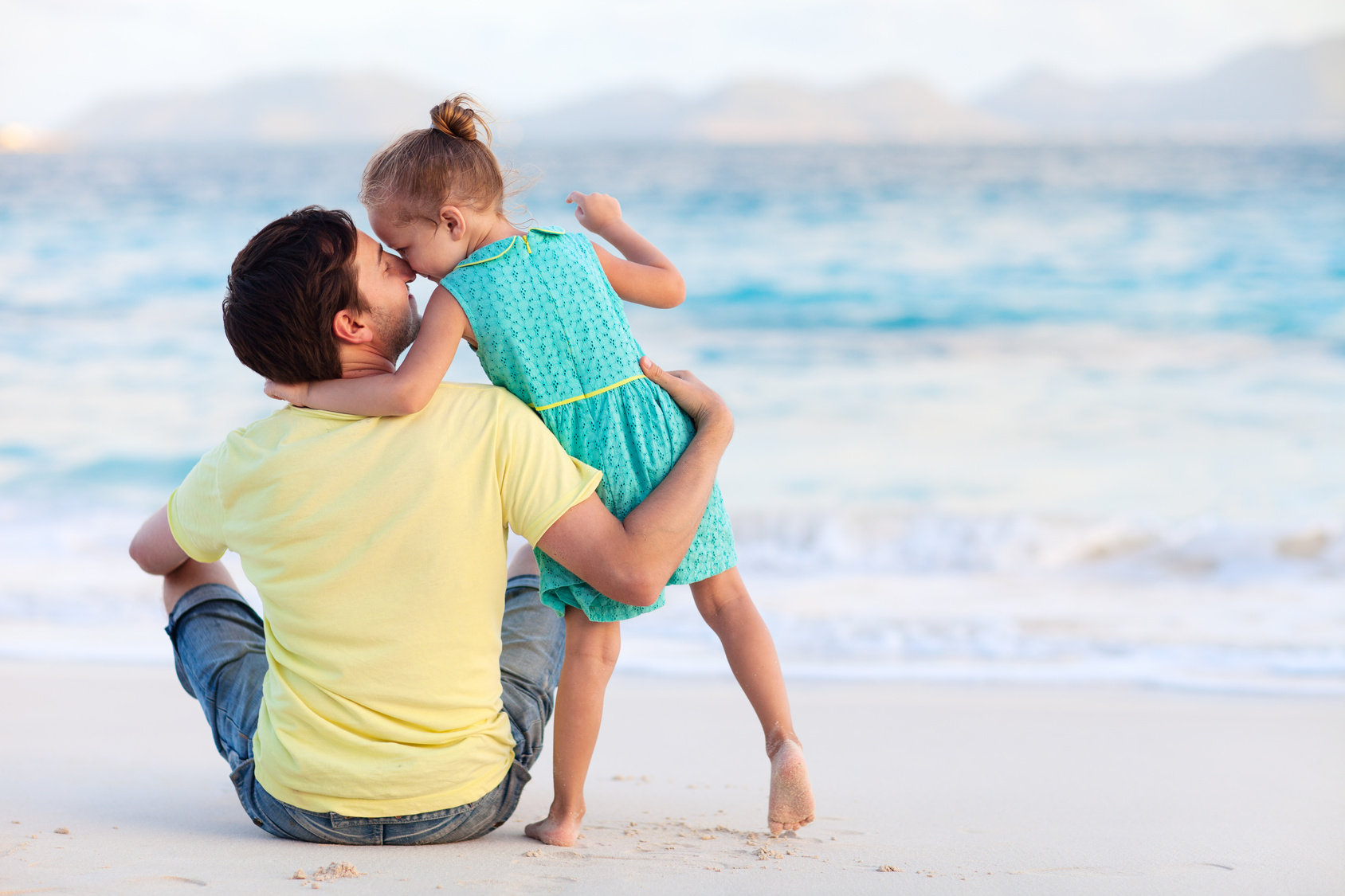 Happy father and his sweet little daughter at beach