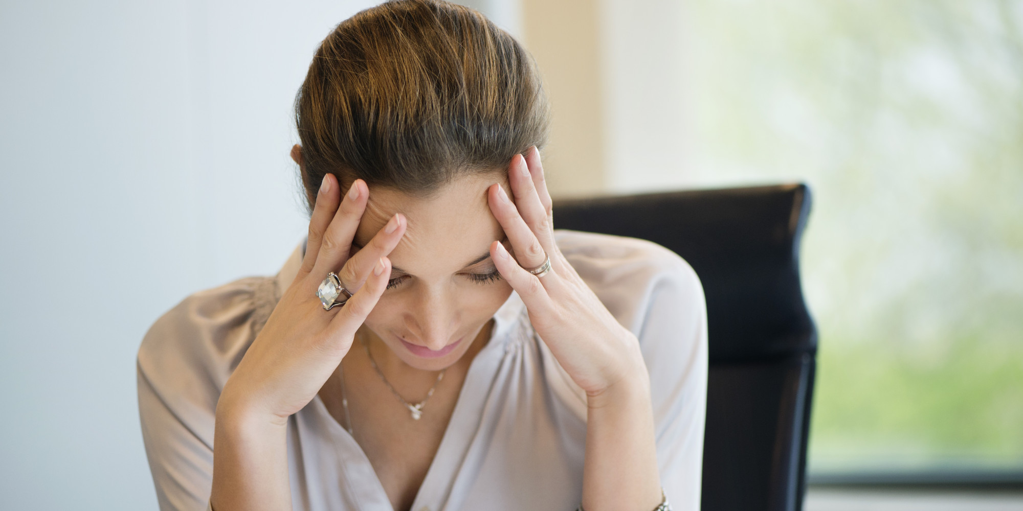 Close-up of a businesswoman suffering from a headache in an office