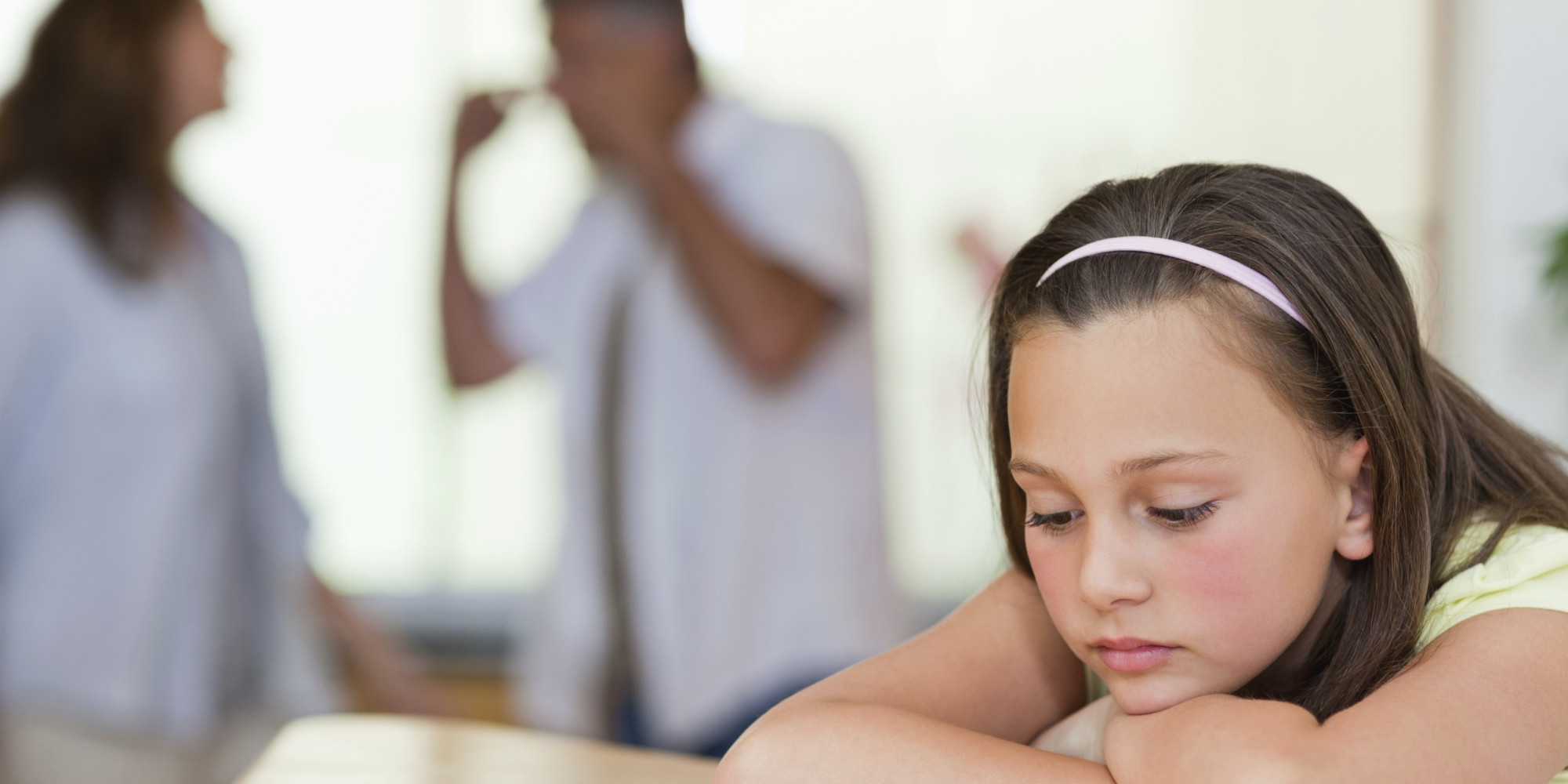 Sad girl with her fighting parents