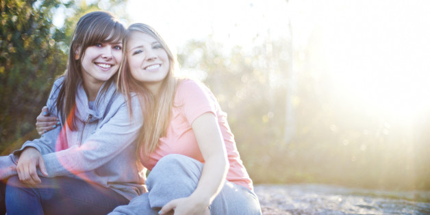 Two Young Women Smiling Together Outside