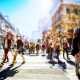 Crowd of anonymous people walking on busy city street