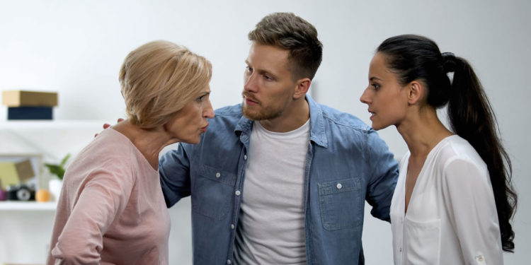 man-trying-to-calm-wife-and-mother-arguing-750x375