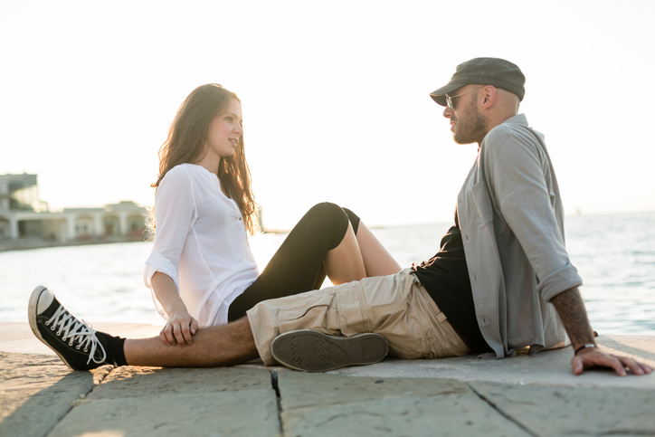 Beautiful couple sitting outdoor at Sunset. City life.