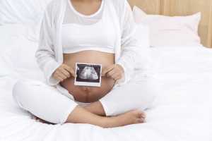 tomography-analyzed-birth-lifestyle-concept-pregnant-young-woman-showing-ultrasound-over-own-belly-growth-baby-sex-212040861