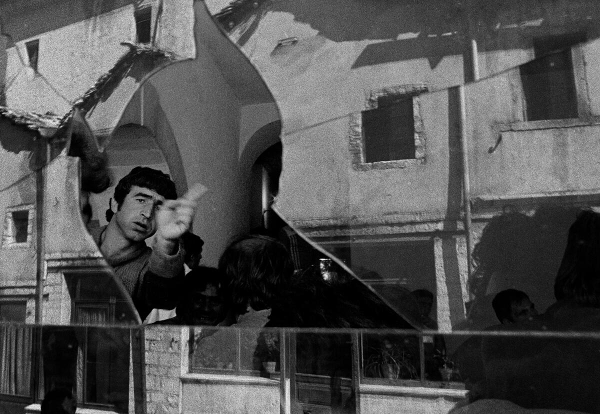 ALBANIA. 1990. Girokaster. In a cafe, reflection on a  broken window.